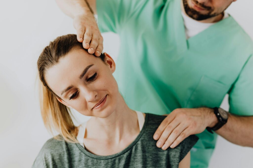 Chiropractor services treating a female patient for neck pain and posture alignment.