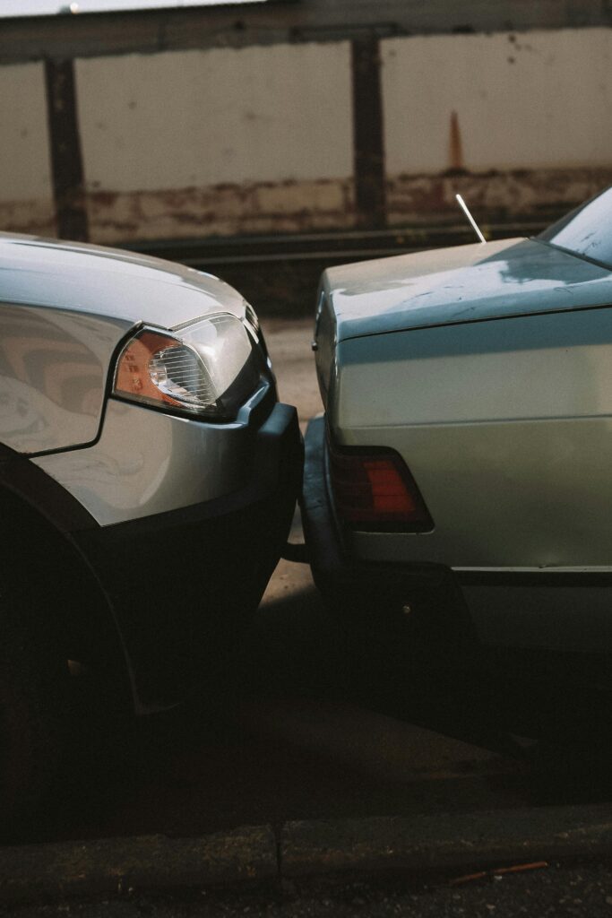 A close-up view showing the aftermath of a rear-end motor vehicle accident in an outdoor setting.